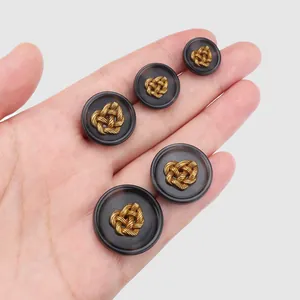 Set of eco-friendly resin suit buttons with woven golden heart design in various sizes.