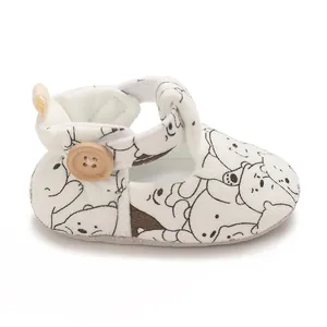 Soft sole baby shoes with cute cartoon bear pattern and decorative wooden button detail