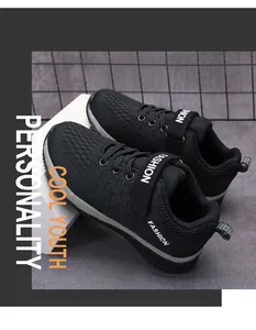 Detailed side view of boys' black flyknit sneakers with 'Fashion' branded straps