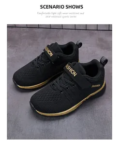 Black boys fly-knit mesh sneakers with gold trim and adjustable velcro strap close-up