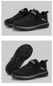 Detail view of black boys' breathable mesh sneakers with non-slip sole and Velcro strap.