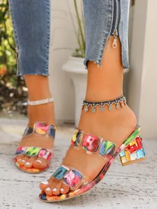 Vibrant colorful gemstone block heel mules with transparent patterned straps for women.