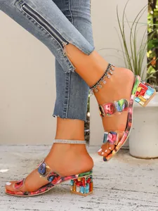 Detailed side view of vibrant women's mid-heel slippers with a unique colorful block heel