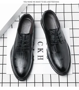 Vista dall'alto di scarpe eleganti da uomo nere con trama a coccodrillo e lacci.