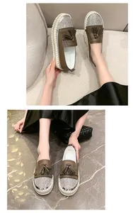 Close-up of brown loafers with rhinestone toes and tassel details on platform soles