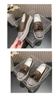 Detail view of brown rhinestone tassel loafers with platform soles and sparkle toe