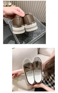 Detail of brown women's loafers with tassel decor and rhinestone platform sole