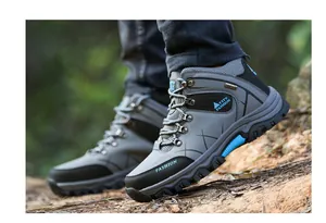Detailed view of durable grey high-top hiking boots for outdoor trekking and mountain