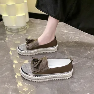 Stylish brown women's platform loafers featuring sparkling rhinestones and decorative tassels.