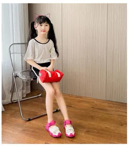 Little Asian girl sitting and wearing pink and white mesh breathable summer sports sandals