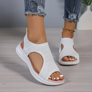 Detailed on-foot view of white mesh platform sandals featuring a breathable cut-out design