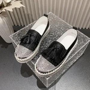 Women's black leather loafers with rhinestone toe, tassels, and white platform sole