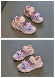 Detailed view of stylish purple and pink breathable mesh kids' sports sandals with velcro
