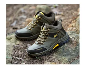 Detailed side view of durable olive green high-top hiking boots on rocky forest ground