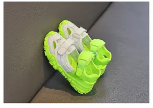 Close-up of neon green and white breathable mesh sporty children's sandals for summer