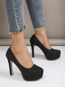 Detailed side view of elegant black glitter platform stiletto heels with 16cm heel