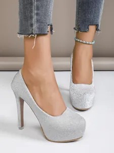 Detailed view of women's silver glitter high heels with 16cm stiletto and platform
