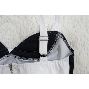 Detalle del tirante ajustable blanco en un top camisero bicolor blanco y negro.