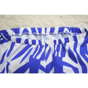 Detailed macro view of the elasticated waistband on a blue and white printed jumpsuit