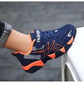 Detail view of a blue and orange boys' mesh running shoe on a foot