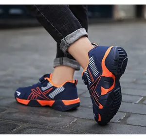 Close-up detail of blue and orange breathable mesh running sneakers for boys outdoors
