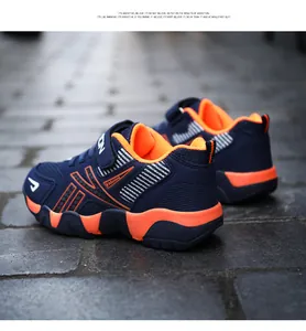 Close-up of navy and orange lightweight breathable running shoes for boys