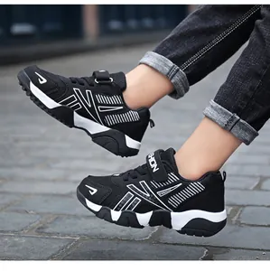 Close-up of black and white breathable mesh sneakers for boys with lightweight soft sole