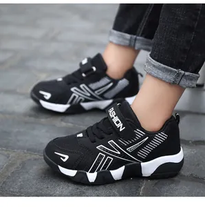 Detailed side view showing the breathable mesh and Velcro strap of these boys' black sneakers
