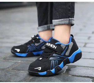 Detailed side view of boys breathable mesh running sneakers in black and blue colors