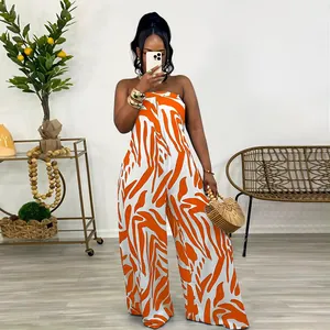 Fashionable orange zebra print strapless wide-leg jumpsuit shown in detailed indoor setting