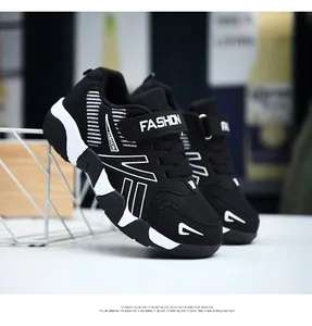 Close-up detail of boys' breathable black mesh running shoes with adjustable straps