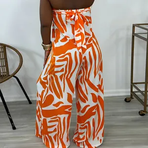 Back view of orange and white striped sleeveless wide leg jumpsuit with tie-back detail.