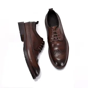 Detailweergave van bruine leren heren Brogue schoenen met klassieke perforaties.