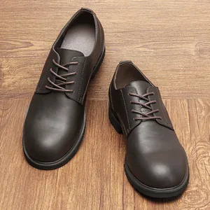 Detailed macro view of men's dark brown leather derby shoes on a wooden background