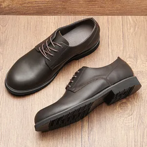 Detailed top view of men's dark brown leather derby shoes on a wood grain background