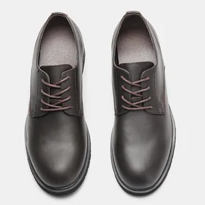 Top-down detail view of classic brown leather men's dress shoes with lace-up design.