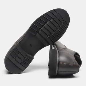 Macro detail showing the anti-slip sole texture of brown leather men's dress shoes.