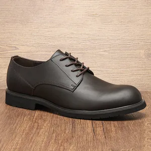 Macro view of a classic men's dark brown genuine leather derby dress shoe on wooden surface