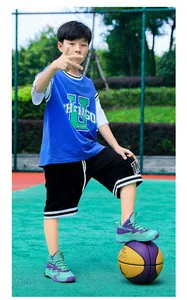 Side view of boy's teal and purple breathable mesh basketball shoes for training