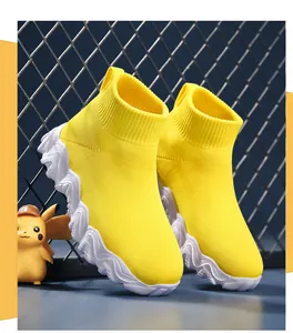 Detailed macro view of vibrant yellow breathable knitted high-top sock shoes for children