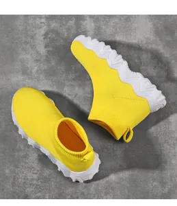 Detailed view of bright yellow breathable flyknit high-top sock sneakers for kids.