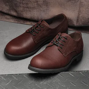 Close-up of men's brown leather derby shoes with suede patches and rubber soles