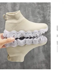 Close-up detail of breathable fly-knit high-top sock shoes for kids with wavy non-slip sole