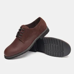 Detail of brown leather dress shoes showing the anti-slip rubber sole and stitching.