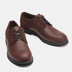 Detailed view of brown genuine leather men's derby shoes with suede texture accents