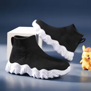 Breathable black flyknit kids sock sneakers with unique thick wavy white soles for boys.