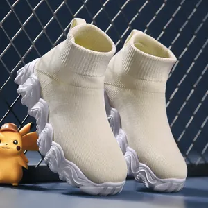 Comfortable boys cream knit high-top sock sneakers featuring stylish wavy white platform soles