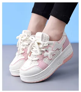 Detailed view of pink and white girls' roller shoes with cute floral decoration