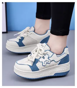 Close-up of white and blue girls chunky platform sneakers with flower patch detail