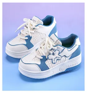 Close-up detail of girls' blue and white retractable roller shoes with cute flower patch